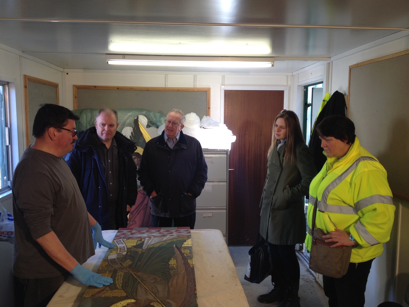 Silvano Cioci-Faux explaining the panel restoration to workshop attendees wearing conservation gloves