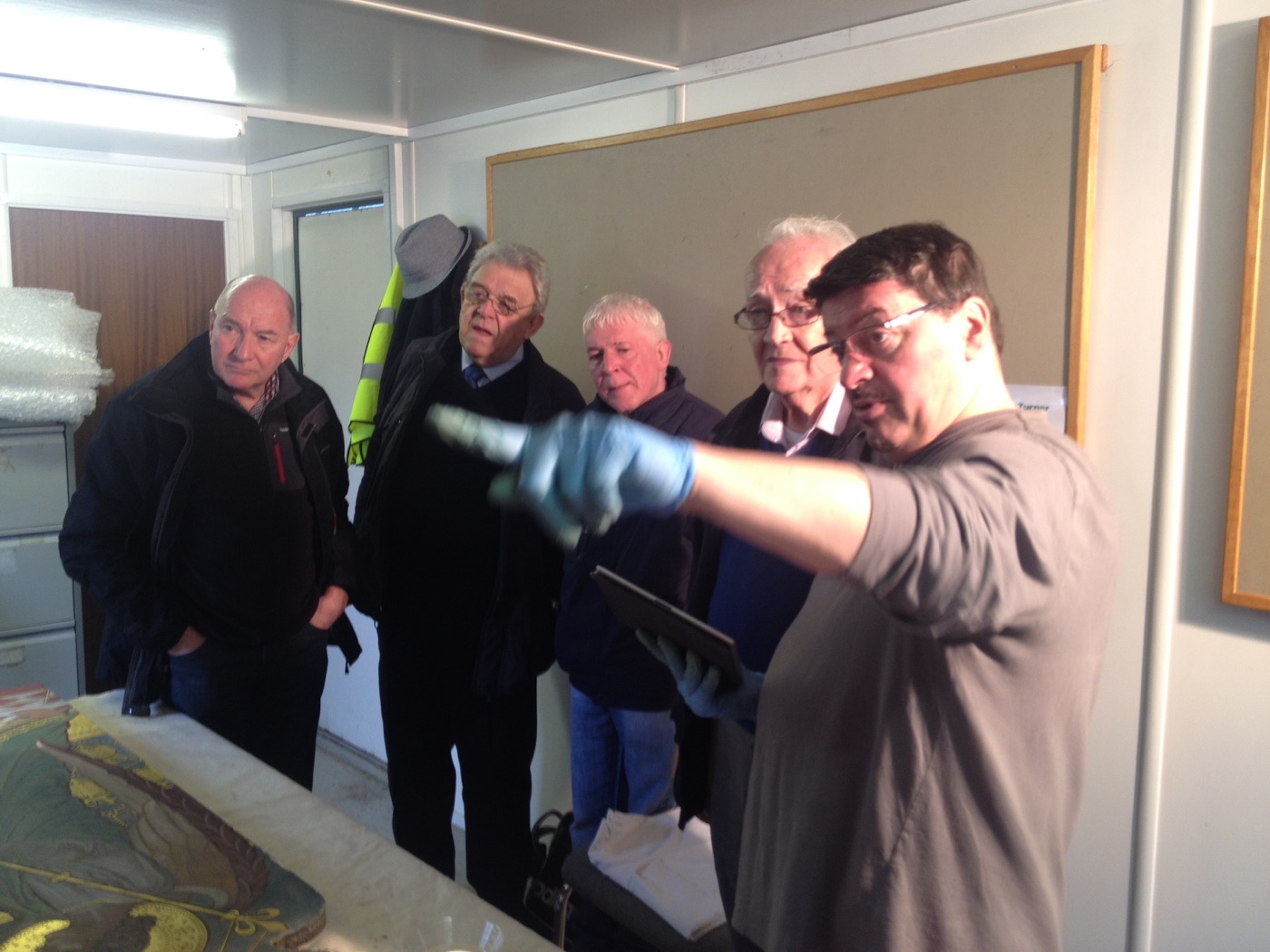 Silvano Cioci-Faux explaining restoration to workshop attendees beside the altar panel