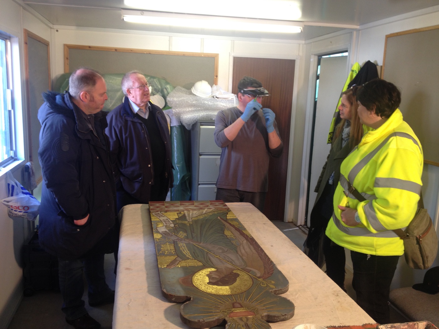 Workshop visitors gathered around the Gabriel panel while Silvano stands by with a magnifying visor