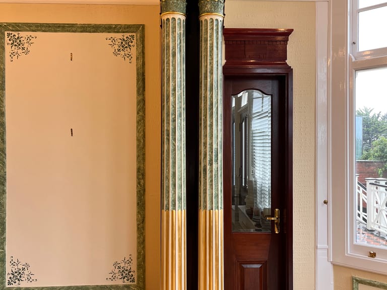 Historic stencil pattern on a decorative wall panel in a Victorian home