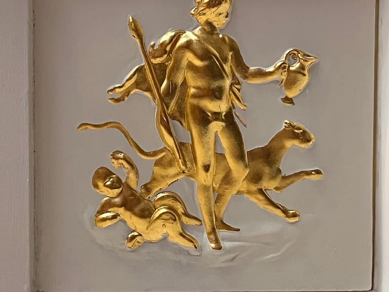 Gilded ceiling plaque with decorative surround in a period interior