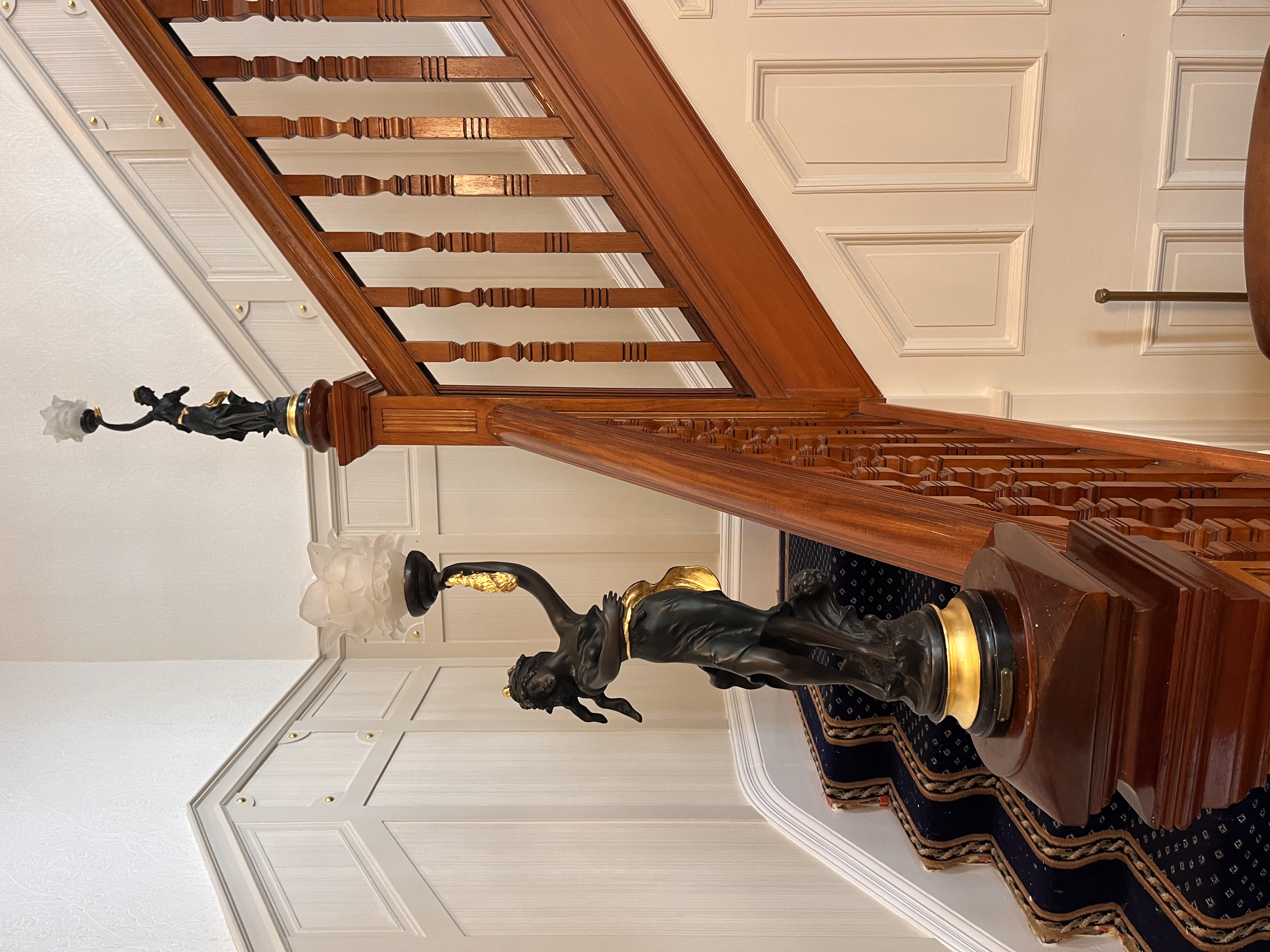 Liberty statues on Victorian staircase