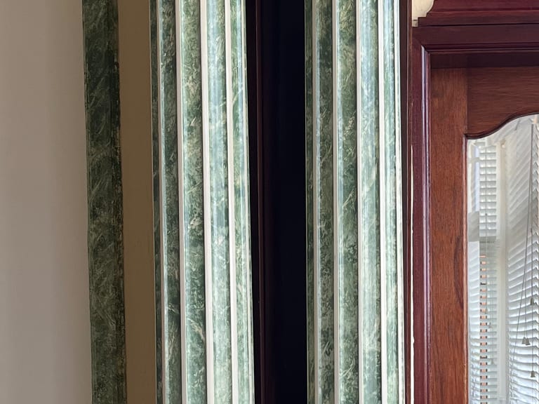Faux marble and gilding on fluted columns in a private home